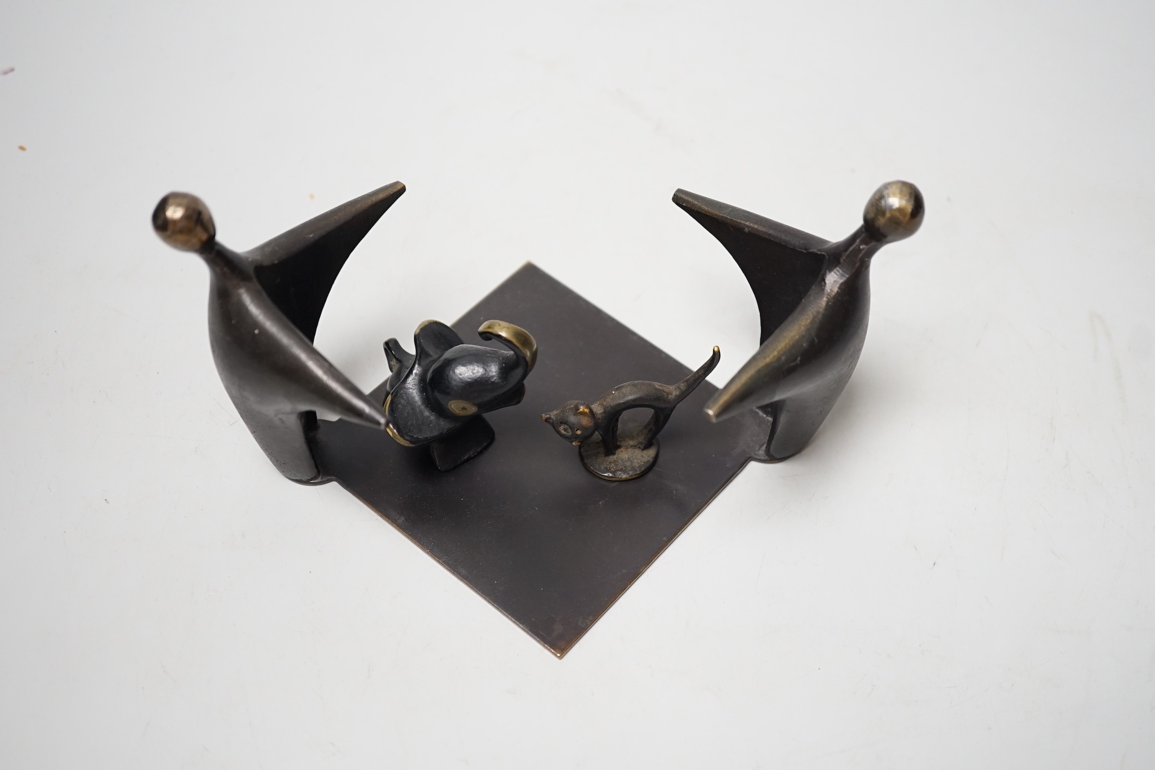 An abstract bronze group, 19cm wide, together with two other figures